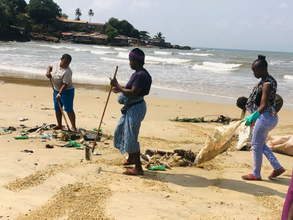 Women cleaning the beach. Photo Credit: Propel Organisation on FaceBook.